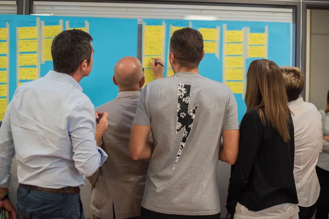 Team reviewing production metrics on a visual management board